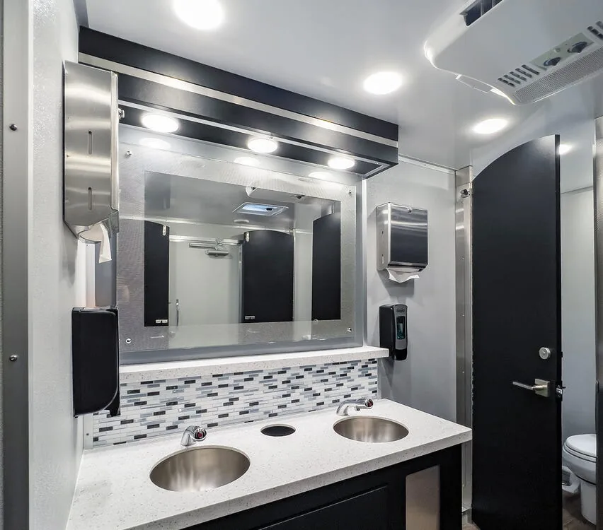 Vanity with two sinks and stall doors.