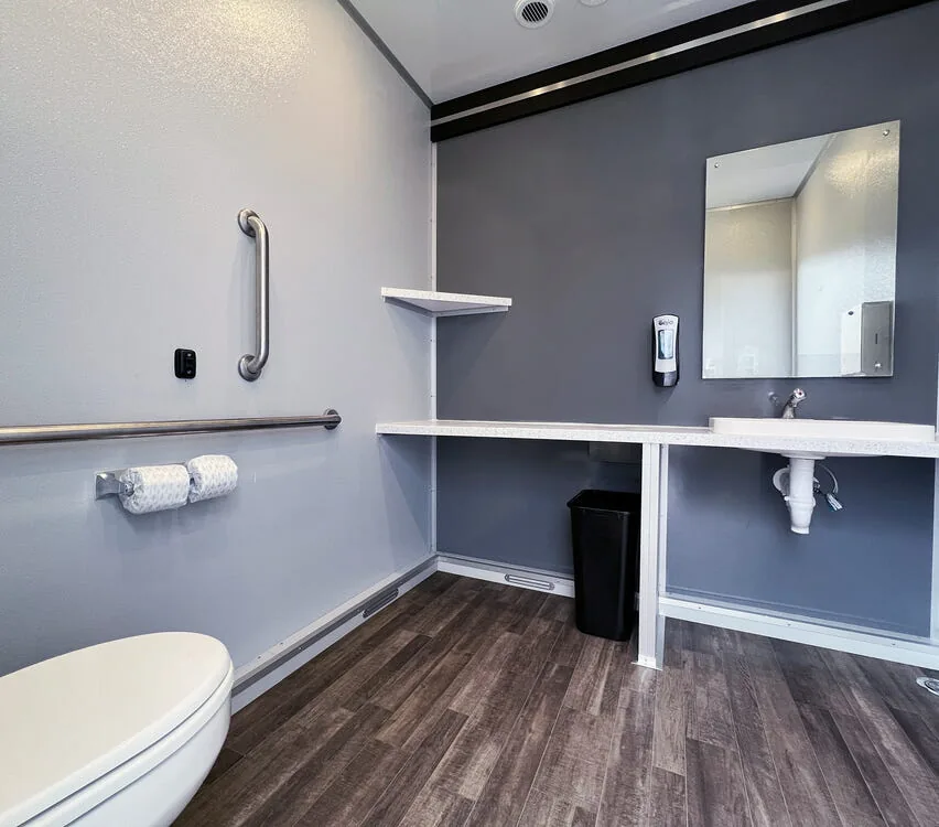 Spacious ADA stall with assist bars.