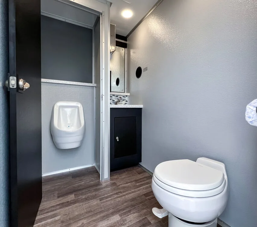 Stall with toilet and urinal.
