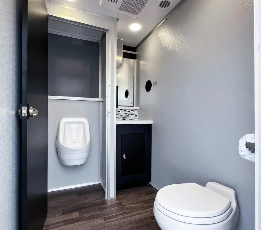 Urinal and toilet in a private stall.