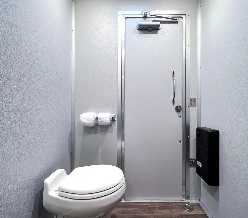 Private stall with porcelain toilet.