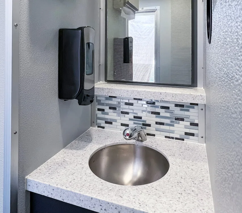 Stainless steel sink with mirror.