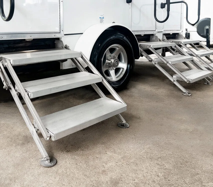 Grooved aluminum stairs with handrails.
