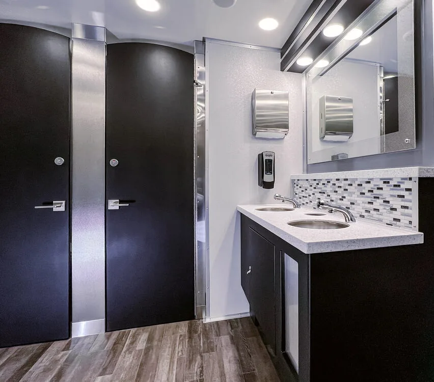 Stall doors and vanity under LED lighting.