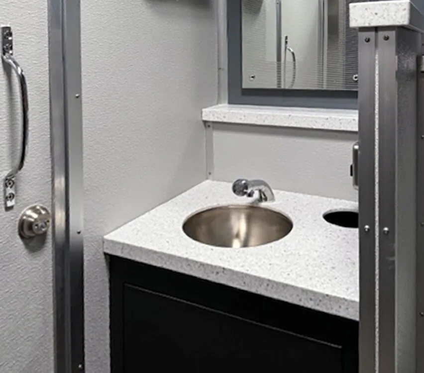 Men's room sink and mirror.