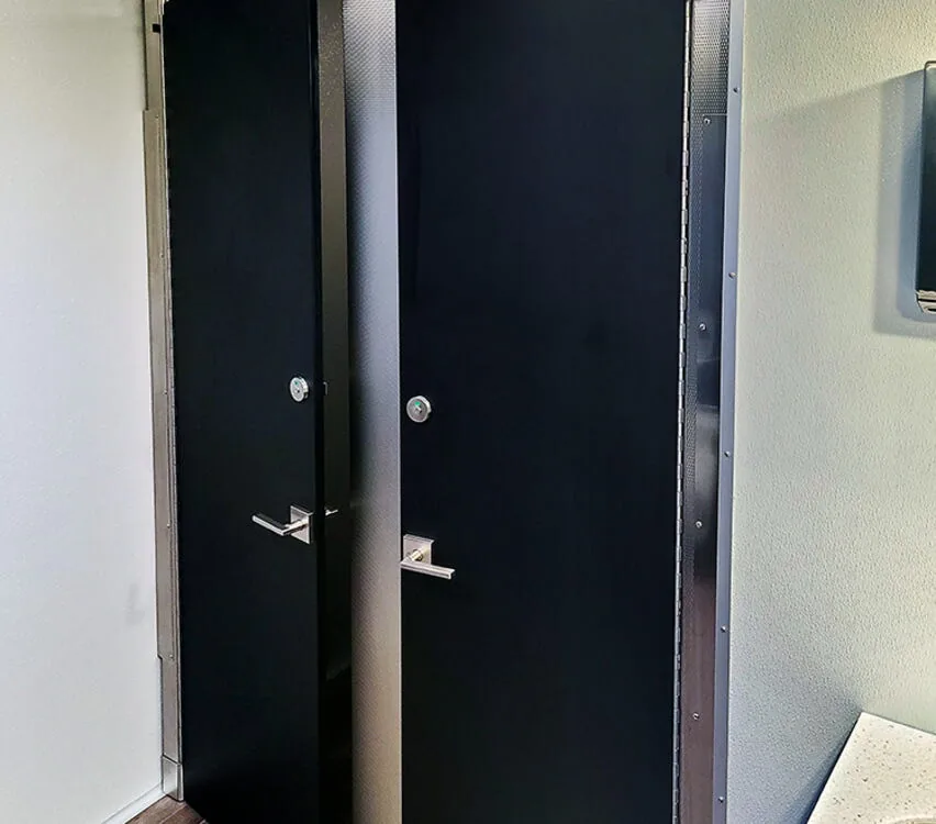 Tall stall doors in the restroom.