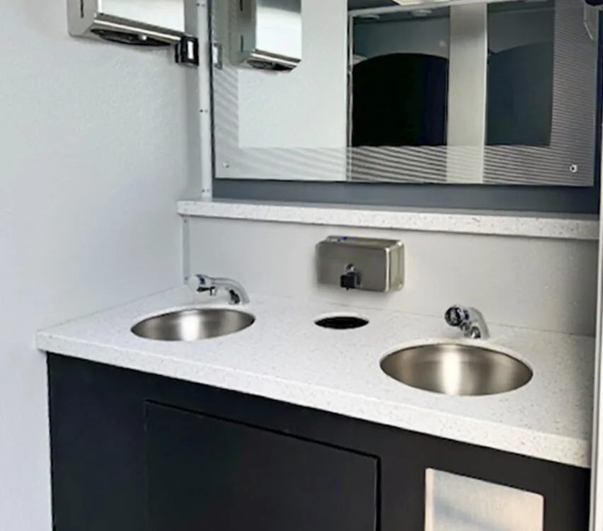 Women's room vanity with two sinks.