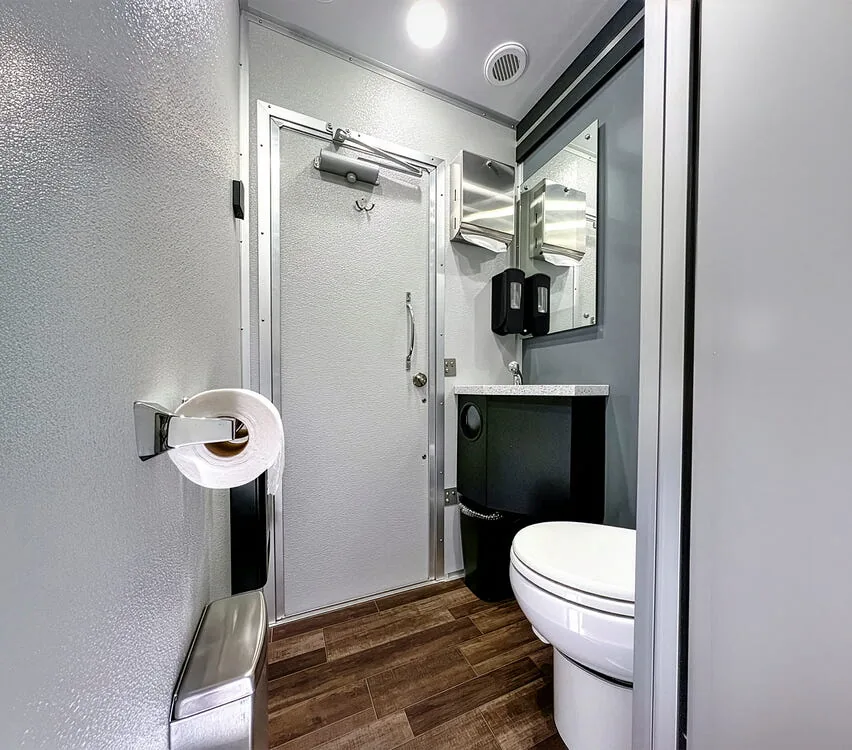 Suite with toilet, vanity and shower door.