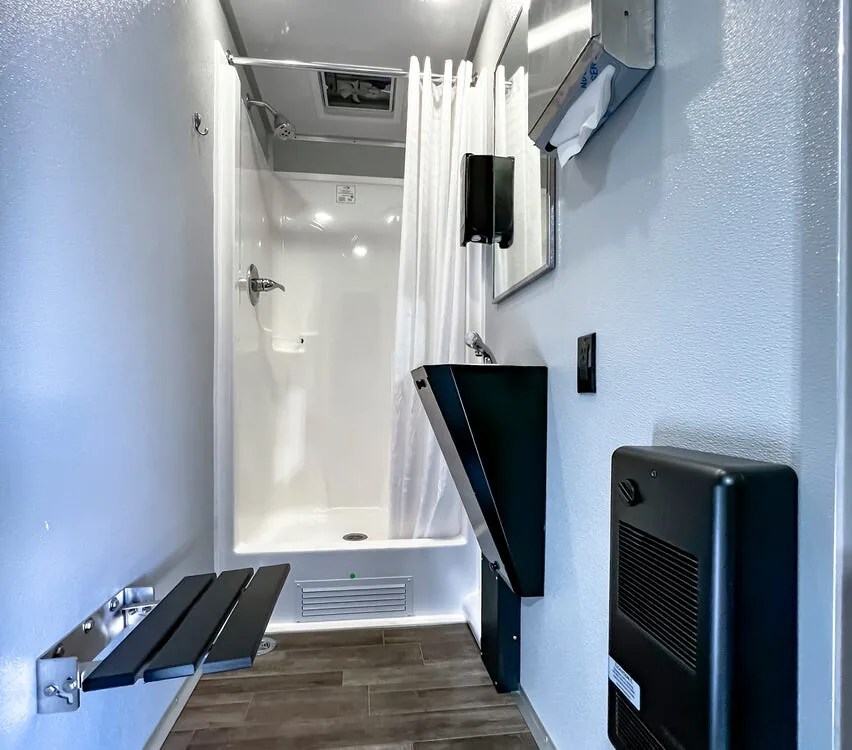 Shower room with dressing area and shower stall.