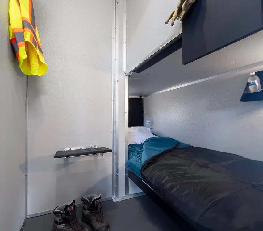 Lower bunk propped up to show storage.