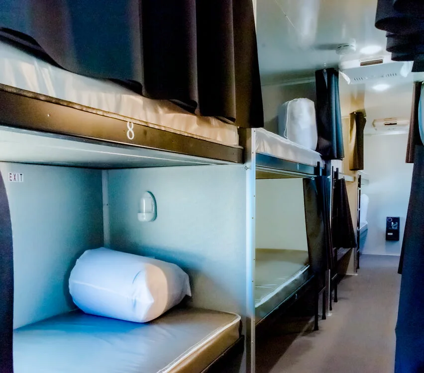Bunk with pillow and blanket.