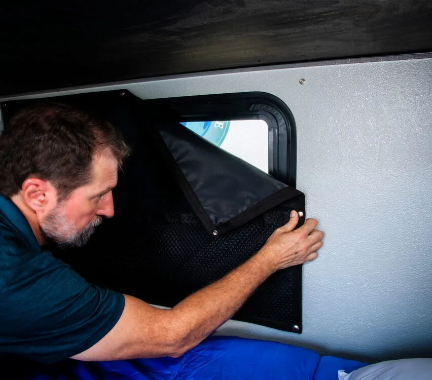 Blackout cover being fitted to a window.