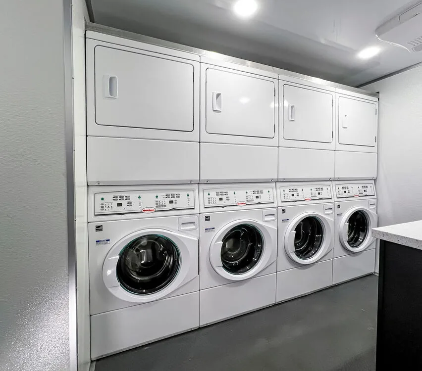 Row of stacked washers and dryers.