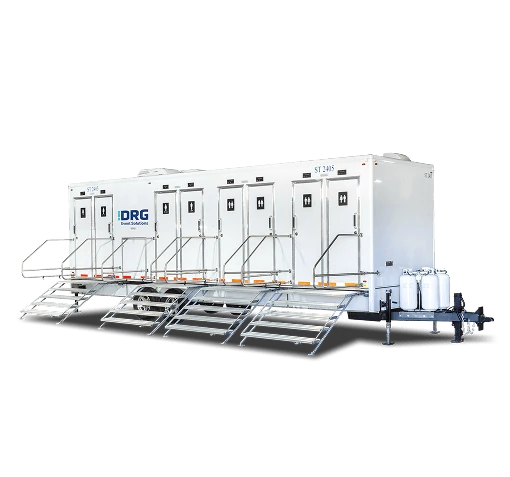 Long white DRG 8-stall shower trailer with several sets of stairs.