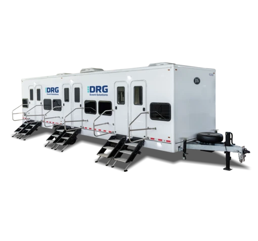 White DRG 12-bed individual room sleeper trailer with three sets of stairs.