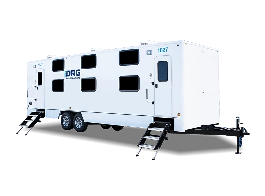 White DRG sleeper trailer with rows of windows and entry stairs.
